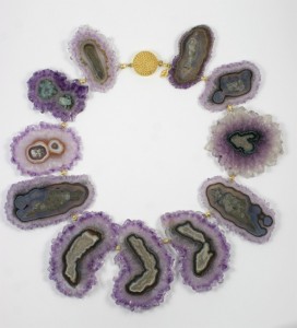 A necklace made of purple and green agate slices.