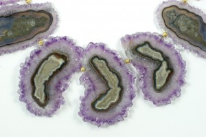 A close up of the purple and green agate slices.