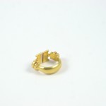 A gold ring with two small flowers on it.