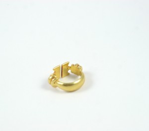A gold ring with two small flowers on it.