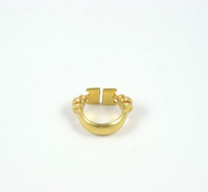 A gold ring with two balls on it.