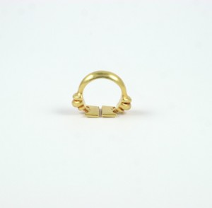 A gold ring with two small chains on it.