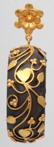 A close up of the gold and black ring