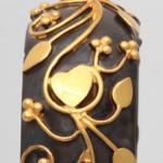 A close up of the gold and black ring