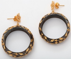 A pair of black and gold earrings on a white background