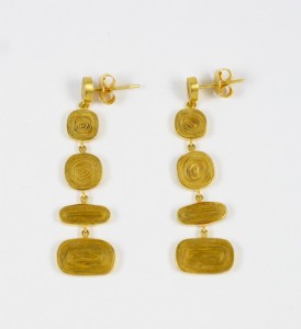 A pair of gold earrings with three different designs.