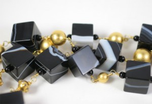 A close up of a necklace with black and white beads