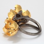 A gold and silver ring with flowers on it