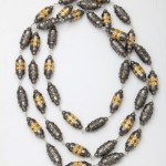 A long necklace with gold and black beads