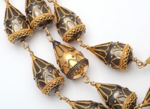 A close up of the necklace on a white background