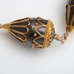 A close up of the gold and black bead