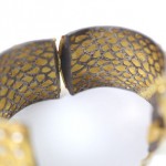 A close up of the side of a snake skin bracelet