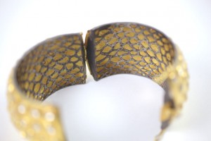 A close up of the side of a snake skin bracelet