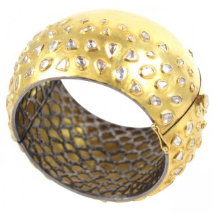 A gold and diamond bangle bracelet.