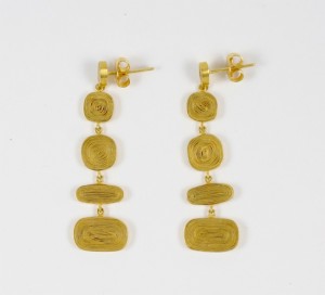 A pair of gold earrings with three squares hanging from them.