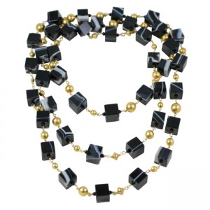 A long necklace of black and gold beads