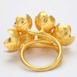 A gold ring with five flowers on it.