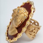 A gold ring with a face on it