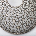 A close up of the front of a necklace