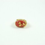 A red ring with gold leaves on it.