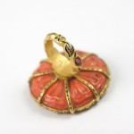 A ring with an orange and gold design on it.
