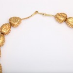 A close up of the necklace on a white background
