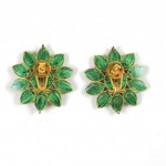 A pair of green and gold earrings.