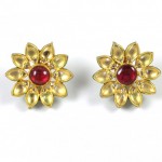 A pair of gold and red earrings.