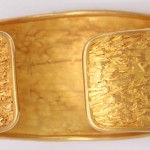 A gold ring with two sections of gold on it.