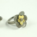 A ring with a flower on it is shown.