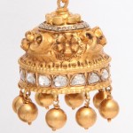 A gold bell with bells hanging from the top.