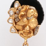 A gold and diamond elephant head with black fur.