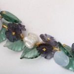 A close up of the leaves and flowers on a bracelet