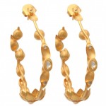 A pair of gold earrings with pearls on them.