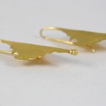 A pair of gold earrings with a bird on them.