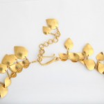 A gold necklace with leaves on it
