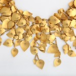 A close up of the necklace made out of gold leaves