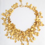 A gold necklace with leaves on it