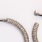 A pair of diamond earrings with two rows of diamonds.
