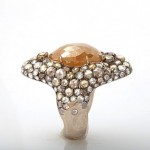 A ring with a large stone and small stones on it.