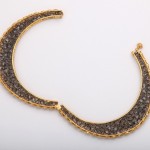 A pair of gold and diamond crescent earrings.