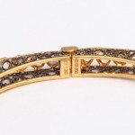 A close up of the side of a gold bracelet