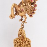 A gold bird with red eyes hanging from the ceiling.