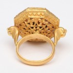 A gold ring with an elephant head on the side.