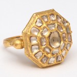 A gold ring with a large diamond in the middle.