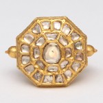 A gold ring with a large diamond in the middle.