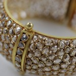 A close up of the gold and diamond bracelet