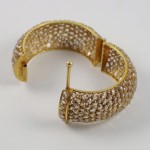A close up of the side of a gold bracelet