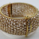 A close up of the side of a gold bracelet