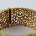A close up of the inside of a gold bracelet